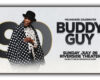Poster advertising Milwaukee celebrating Buddy Guy with a photo of him in a polka-dot coat; text reads 'Milwaukee Celebrates Buddy Guy' and 'Sunday July 26 Riverside Theater'.
