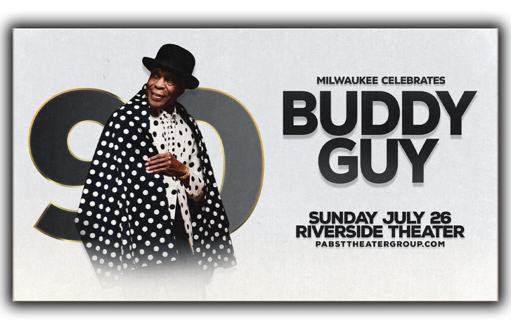 Poster advertising Milwaukee celebrating Buddy Guy with a photo of him in a polka-dot coat; text reads 'Milwaukee Celebrates Buddy Guy' and 'Sunday July 26 Riverside Theater'.