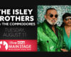 Concert poster: The Isley Brothers with The Commodores advertised for Tuesday, August 11 at the Wisconsin State Fair Main Stage. Sponsor: Five Nine (banner at bottom).